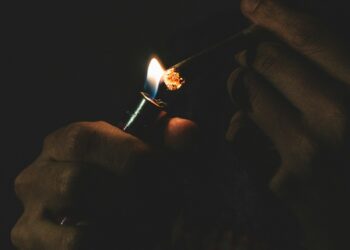 man lighting cigarette
