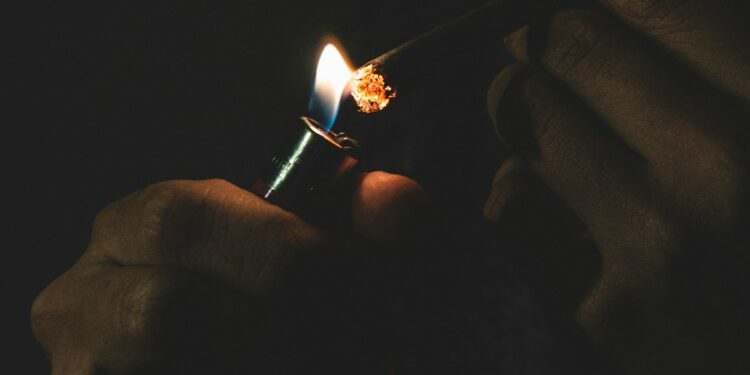 man lighting cigarette