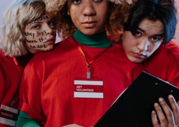 Three People in Red Crew Neck Shirt Uniform