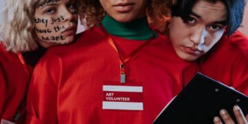 Three People in Red Crew Neck Shirt Uniform