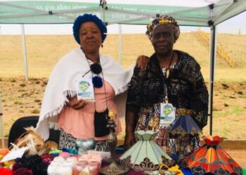 :- Rosina Kabini (left) a craftswoman who designs handmade items from animal skin, wood and raffia is with Betty Mahlangu (right) displaying her crafted unique glass creation.