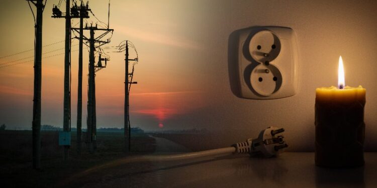Blackout, candle with a socket, power cut - no electricity, the flame of a candle, circuit breaker, electrical outlet plug