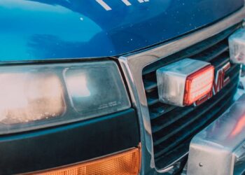 Detailed shot of a blue paramedics ambulance showing the front grill and headlight.