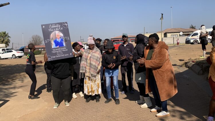 Protesters peacefully singing outside of Vosman Police Station. While waiting for the communication officer to speak to them.