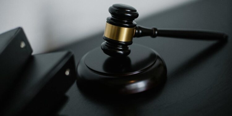Close-up of a wooden gavel on a desk, symbolizing justice and legal authority.